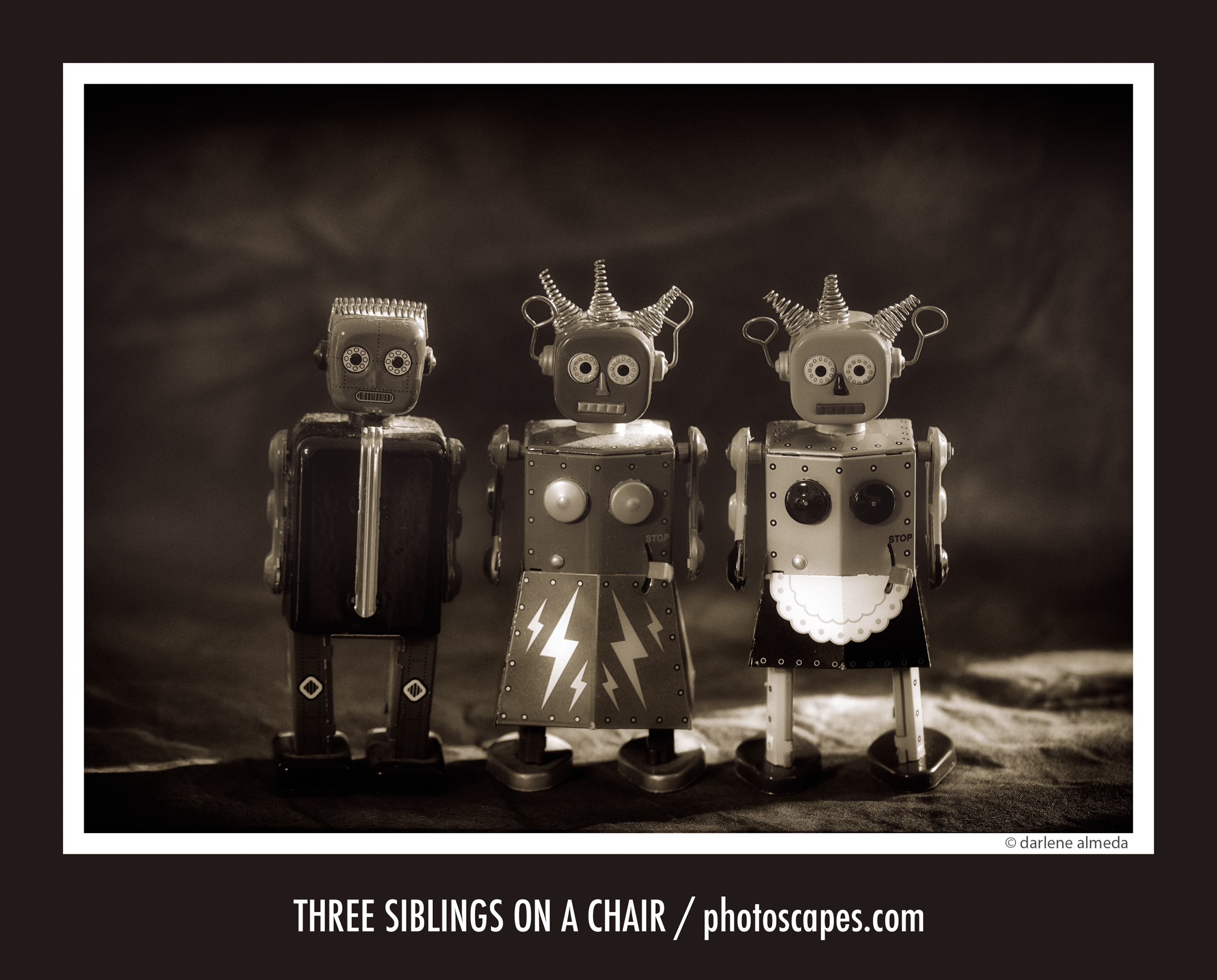 THREE SIBLINGS ON A CHAIR