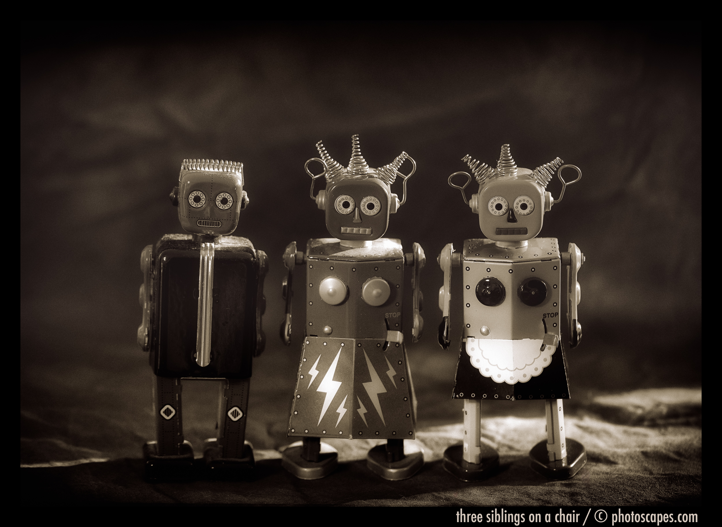 THREE SIBLINGS ON A CHAIR